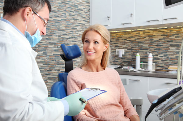 Woman talking to dentist